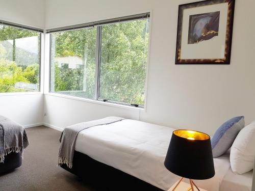 a bedroom with a bed and a large window at qTownPad in Queenstown