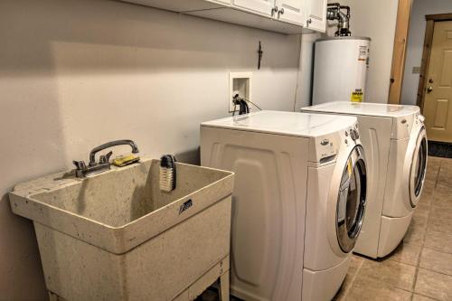 a laundry room with a washing machine and a sink at Waterfront Pike Lake Retreat Snowmobile Paradise in Park Falls