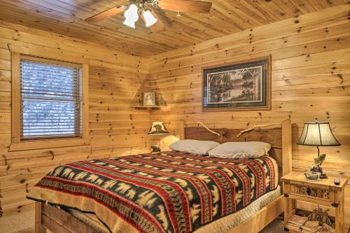 a bedroom with a bed in a log cabin at Waterfront Pike Lake Retreat Snowmobile Paradise in Park Falls