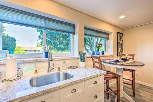 a kitchen with a sink and two windows at Seattle Area Studio with Fireplace-2 Mi to State Park in Kenmore