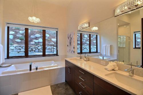 a bathroom with two sinks and a large mirror at Pahtos Retreat Luxe White Salmon Home Hot Tub in White Salmon