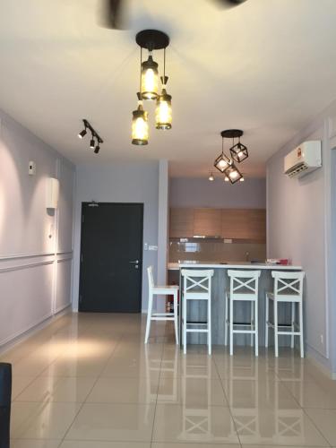 a living room with a kitchen and a table at Lodge Alpha LaVista at Emira Residence Shah Alam in Shah Alam