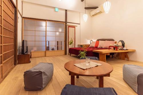 a living room with a couch and a table at back alley residence Hibi in Osaka