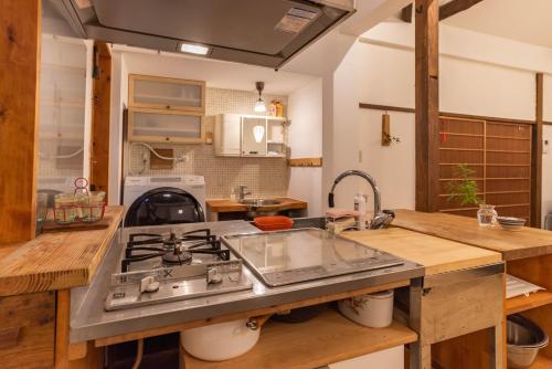 a kitchen with a sink and a stove at back alley residence Hibi in Osaka