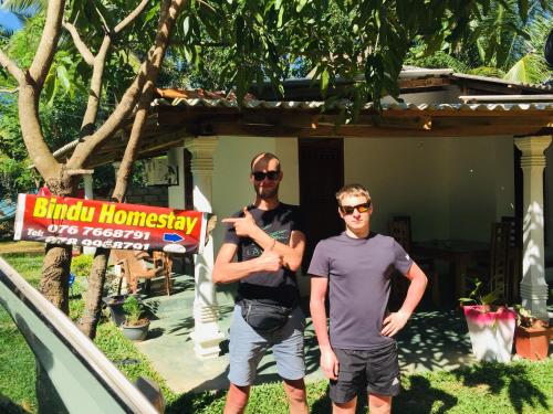 two men are standing in front of a house at Bindu Homestay in Wellawaya