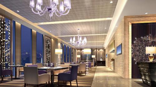 a restaurant with tables and chairs and chandeliers at Crowne Plaza Nanning City Center by IHG in Nanning