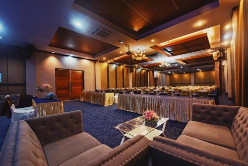 a conference room with tables and chairs in a room at Nana Beach Hotel & Resort in Pathiu