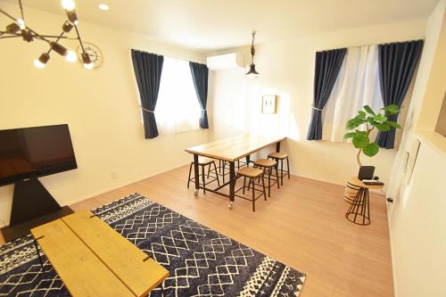 a living room with a table and a dining room at FINOA Residential Suite Asakusa/Oshiage Skytree in Tokyo