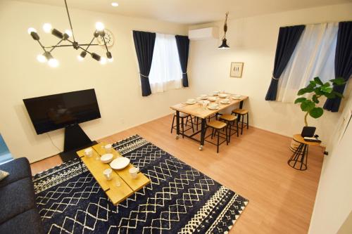 a living room with a table and a dining room at FINOA Residential Suite Asakusa/Oshiage Skytree in Tokyo