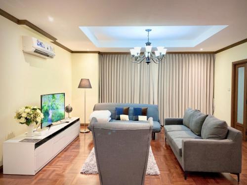a living room with a couch and a table at NT Place Sukhumvit Suites in Bangkok
