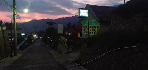 a building with a sign on top of it at night at Homestay Anggun Bromo in Bromo
