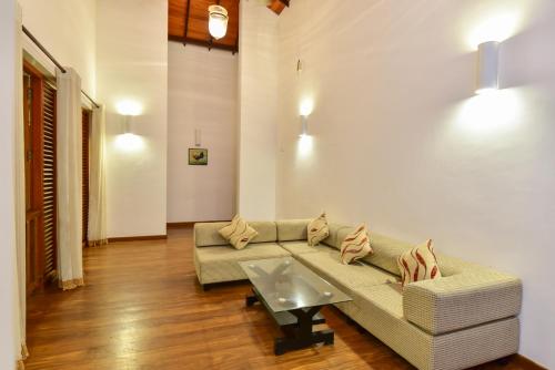 a living room with a couch and a coffee table at Romaya Villas - Habaraduwa in Unawatuna