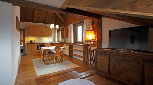 a kitchen and dining room with a table and a television at Appartement Elisabeth in Kitzbühel