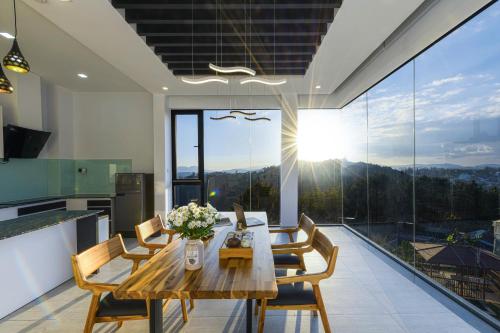 a kitchen and dining room with a table and chairs at Q&P Smart Ville in Da Lat
