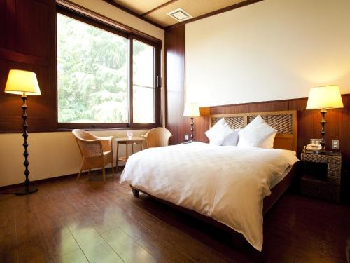 Tempat tidur dalam kamar di Hotel Allamanda大人の隠れ家リゾート