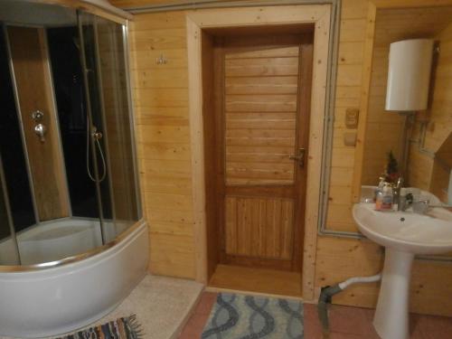 a bathroom with a shower and a sink at Karpatskiy Domik Izki in Izki