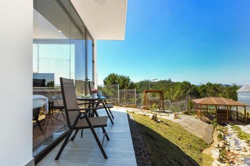 a balcony of a house with a table and chairs at Q&P Smart Ville in Da Lat