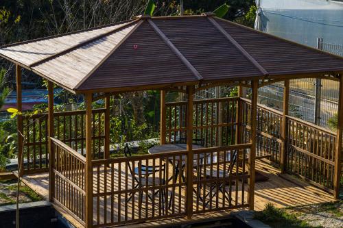 a wooden gazebo with a wooden roof at Q&P Smart Ville in Da Lat