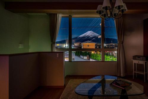 a room with a view of a mountain through a window at Villa Fuji Bon Voyage Sora in Fujikawaguchiko