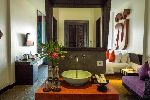 a bathroom with a bowl sink in the middle of a room at Golden Temple Villa in Siem Reap
