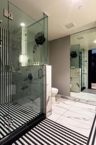 a bathroom with a glass shower and a toilet at Hotel Indigo Los Angeles Downtown in Los Angeles