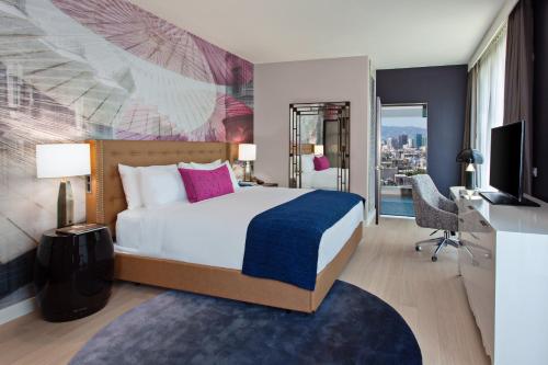a hotel room with a bed and a tv at Hotel Indigo - Los Angeles Downtown, an IHG Hotel in Los Angeles