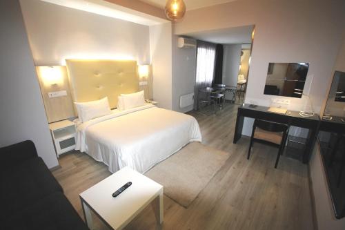 a hotel room with a white bed and a desk at Casablanca Suites & Spa in Casablanca