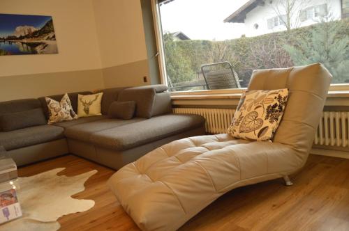 a living room with a couch and a chair at Yeti Lux - Family Garden Lodge in Garmisch-Partenkirchen
