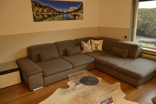 a living room with a couch and a table at Yeti Lux - Family Garden Lodge in Garmisch-Partenkirchen