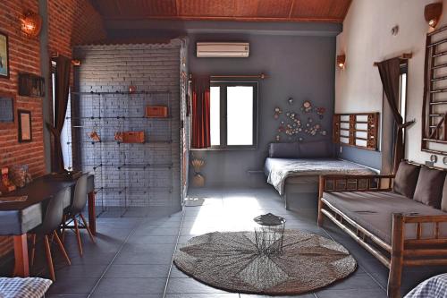 a living room with a couch and a table at The Happy Bird B&B in Hoi An