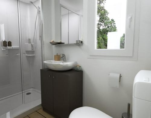 a bathroom with a sink and a shower and a toilet at Camping Torre Castiglione in Torre Lapillo