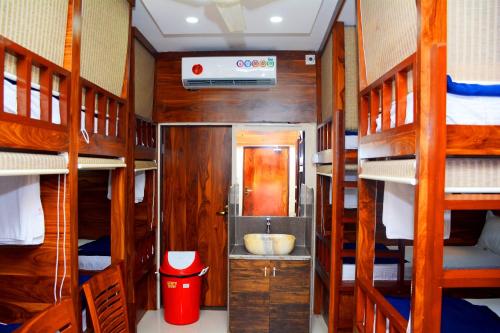 a small room with a sink in a room with bunk beds at Hotel Nest N Rest - Mumbai in Mumbai