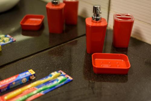 a counter top with toothbrushes and toothbrushes at Beautiful Apartments at Tarudhan Valley Golf Resort, Manesar in Gurgaon