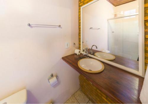 a bathroom with a sink and a mirror at Pousada Pedra D'Água Pipa in Pipa
