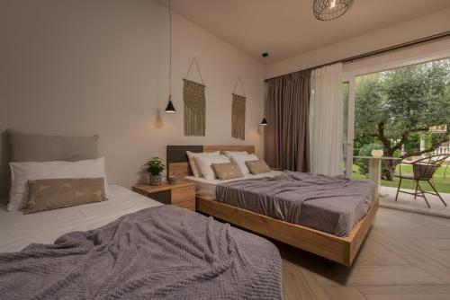 A bed or beds in a room at Aeolos Boutique Hotel and Suites