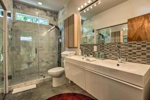 a bathroom with a toilet and a sink and a shower at Mod Austin House with Deck, Yard and Walkable Location in Austin