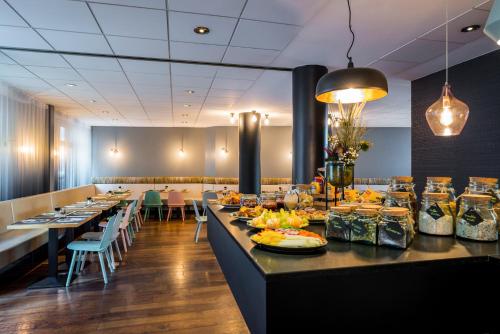 a restaurant with long tables with food on them at Mercure Hotel Berlin Zentrum Superior in Berlin