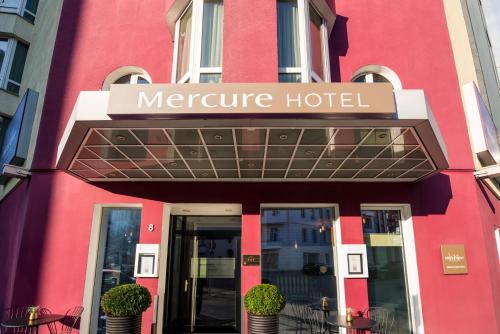 a building with a sign on the front of it at Mercure Hotel Berlin Zentrum Superior in Berlin