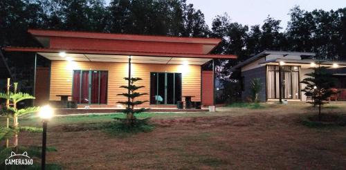 a small house with lights on in a yard at เฟรนด์แคมป์ in Khao Kho