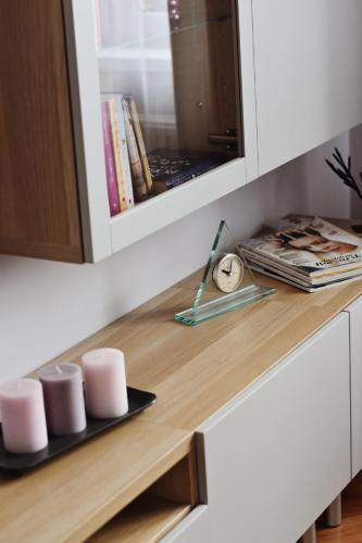 a wooden counter in a kitchen with cups and magazines at Cozy apartment in Tarnow in Tarnów