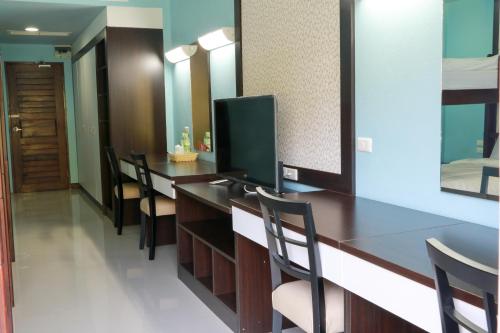 a conference room with chairs and a desk with a television at The Thai Elephant Conservation Center Lampang in Lampang