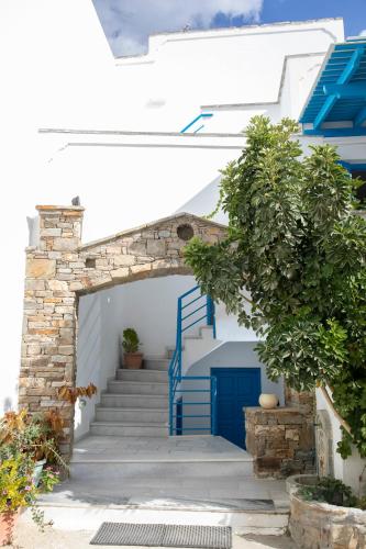 a stairway with blue and white stairs and a blue door at Flora Apartments & Studios in Agia Anna Naxos
