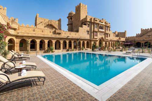 a courtyard with a swimming pool in a building at WelcomHeritage Mohangarh Fort in Jaisalmer