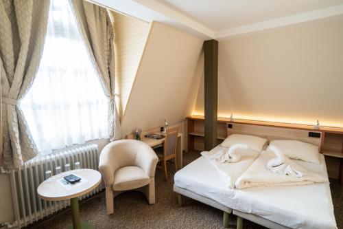 מיטה או מיטות בחדר ב-Szilvia Gästehaus