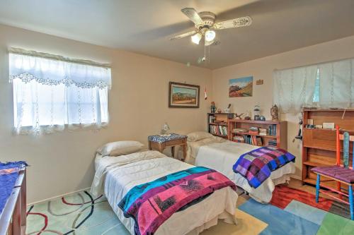 a bedroom with two beds and a ceiling fan at Catalina Mtn Views, BBQ Ready Cozy Tucson House in Tucson