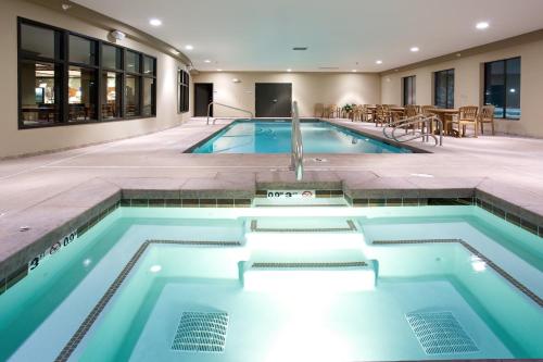 a swimming pool with a fountain in a house at Holiday Inn Express Hotel & Suites Lander by IHG in Lander