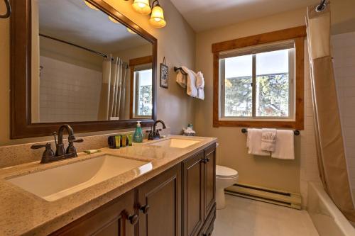 a bathroom with a sink and a mirror and a toilet at Keystone Home on Snake River with Hot Tub and Views! in Keystone