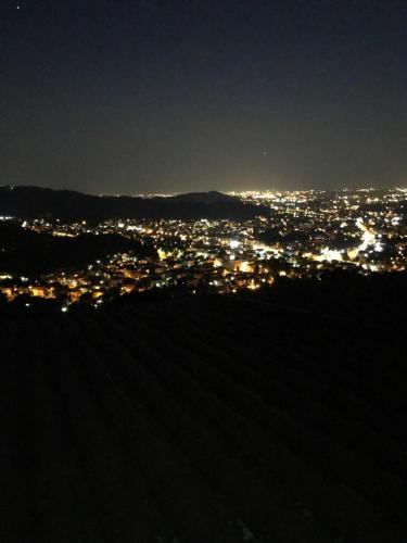 a view of a city lit up at night at LE LANTERNE in Villa dʼAlmè