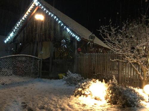 a house covered in snow with lights on it at Bed & Breakfast Chez Lips in Oberbildein