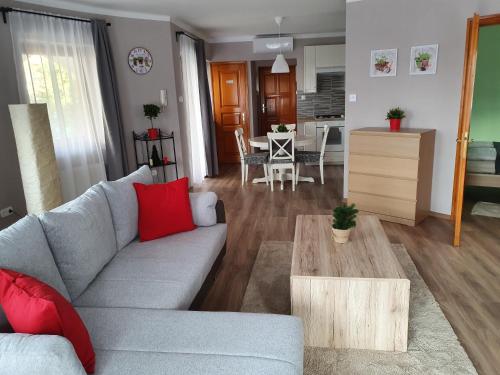 a living room with a couch and a table at Pannonia Apartman in Esztergom